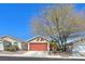 Charming single-story home featuring a terracotta-colored garage door and desert landscaping at 8472 W Gilmore Ave, Las Vegas, NV 89129