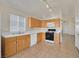 Kitchen with light wood cabinets and white appliances at 8472 W Gilmore Ave, Las Vegas, NV 89129