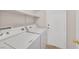This laundry room features a washer, a dryer, and shelving at 8472 W Gilmore Ave, Las Vegas, NV 89129