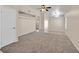 Spacious carpeted living room with neutral walls at 8472 W Gilmore Ave, Las Vegas, NV 89129