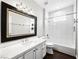 Modern bathroom featuring a large mirror, white vanity, and a shower-tub combination at 8705 Red Brook Dr # 203, Las Vegas, NV 89128
