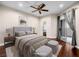Comfortable bedroom features a ceiling fan, walk-in closet, and sliding door to balcony at 8705 Red Brook Dr # 203, Las Vegas, NV 89128