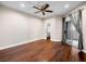 Cozy bedroom featuring wood floors, a ceiling fan, and sliding glass doors, with an attached closet at 8705 Red Brook Dr # 203, Las Vegas, NV 89128