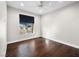 Bright bedroom with hardwood floors, ceiling fan, and a window with a view at 8705 Red Brook Dr # 203, Las Vegas, NV 89128