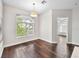 Well-lit dining area featuring wood floors, a stylish light fixture, and a large window at 8705 Red Brook Dr # 203, Las Vegas, NV 89128