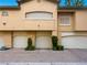 Multi-car garage with well-maintained landscaping in a modern designed home with neutral color palette at 8705 Red Brook Dr # 203, Las Vegas, NV 89128
