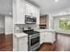 Kitchen offers white cabinets, stainless appliances, tile backsplash and bar seating at 8705 Red Brook Dr # 203, Las Vegas, NV 89128