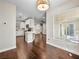 Open concept kitchen area showcasing white cabinets, tile backsplash, and wooden floors, with natural light at 8705 Red Brook Dr # 203, Las Vegas, NV 89128