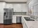 Kitchen features stainless steel appliances, white cabinets, and tiled backsplash at 8705 Red Brook Dr # 203, Las Vegas, NV 89128
