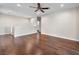 Spacious living area with wood floors, ceiling fan, and bright lighting, complemented by neutral walls at 8705 Red Brook Dr # 203, Las Vegas, NV 89128