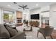 Bright living room features a stone fireplace, hardwood floors, and access to a balcony at 8705 Red Brook Dr # 203, Las Vegas, NV 89128