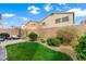 Backyard with artificial turf, stone landscaping, patio, and privacy fence at 9120 Mastodon Ave, Las Vegas, NV 89149