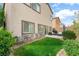 Backyard featuring a small lawn, patio area with furniture, and stucco exterior at 9120 Mastodon Ave, Las Vegas, NV 89149