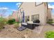 Backyard featuring a patio, furniture, minimal landscaping, and partial lawn area at 9120 Mastodon Ave, Las Vegas, NV 89149