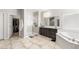 This bathroom has dual sinks, a walk in shower, soaking tub, and access to a walk-in closet at 9120 Mastodon Ave, Las Vegas, NV 89149