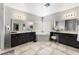 This luxurious bathroom features dual sinks, a soaking tub, tiled floors, and great lighting at 9120 Mastodon Ave, Las Vegas, NV 89149