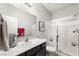 Bathroom featuring a vanity with marble countertop, framed mirror, a shower with glass doors and tile surround at 9120 Mastodon Ave, Las Vegas, NV 89149