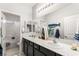 This bathroom features dual sinks, a shower/tub combo, vanity lighting, and lots of space at 9120 Mastodon Ave, Las Vegas, NV 89149