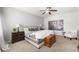 Bedroom with decorative elements, including lamps, art, wooden chest and ceiling fan at 9120 Mastodon Ave, Las Vegas, NV 89149