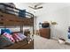 Bedroom with a bunk bed, dinosaur wall decor, dresser, and neutral carpeting at 9120 Mastodon Ave, Las Vegas, NV 89149