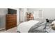 This bedroom features neutral paint, carpet, a shelving unit, dresser with TV, and desk at 9120 Mastodon Ave, Las Vegas, NV 89149