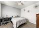 This bedroom features neutral paint, a ceiling fan, carpet, and a desk with chair at 9120 Mastodon Ave, Las Vegas, NV 89149