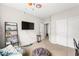 This bedroom features carpet, closet doors, a flat screen TV, and playful decor at 9120 Mastodon Ave, Las Vegas, NV 89149