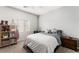 This bedroom features neutral paint, carpet, a desk, and a side table with drawers at 9120 Mastodon Ave, Las Vegas, NV 89149