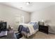 Bedroom with a double bed, a nightstand, a window with blinds, and an office desk with a computer at 9120 Mastodon Ave, Las Vegas, NV 89149