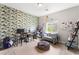 This bedroom features nautical themed wallpaper, two desks, and neutral carpet at 9120 Mastodon Ave, Las Vegas, NV 89149