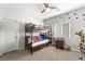 Bright bedroom featuring a bunk bed, carpet flooring, and decorative wall accents at 9120 Mastodon Ave, Las Vegas, NV 89149