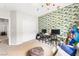 This bedroom features nautical themed wallpaper, two desks, and neutral carpet at 9120 Mastodon Ave, Las Vegas, NV 89149