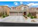 Charming two-story home featuring a three-car garage and landscaped front yard at 9120 Mastodon Ave, Las Vegas, NV 89149