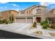 Charming two-story home featuring a three-car garage and landscaped front yard at 9120 Mastodon Ave, Las Vegas, NV 89149