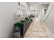 Bright hallway featuring tile flooring, neutral paint and decor, leading to living space at 9120 Mastodon Ave, Las Vegas, NV 89149