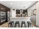 Modern kitchen with stainless steel appliances, granite countertops, and dark cabinets at 9120 Mastodon Ave, Las Vegas, NV 89149