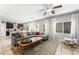 Spacious living room open to the kitchen with tile floors, neutral colors, and a ceiling fan at 9120 Mastodon Ave, Las Vegas, NV 89149