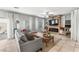 Cozy living room with a rustic fireplace, modern sofa, and plenty of natural light at 9120 Mastodon Ave, Las Vegas, NV 89149