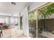 Bright open living room with natural light, tile floors, and views of the patio at 9120 Mastodon Ave, Las Vegas, NV 89149