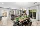 Open living space with a dining table, sofa, sliding glass doors, and a fireplace with a flatscreen TV at 9120 Mastodon Ave, Las Vegas, NV 89149