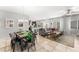 Open floor plan showcasing a dining area, kitchen, and living area with a large sofa and tile flooring at 9120 Mastodon Ave, Las Vegas, NV 89149