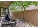 Outdoor patio with a fire pit and chairs surrounded by mature landscaping and privacy walls at 9120 Mastodon Ave, Las Vegas, NV 89149