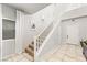 Bright foyer with staircase, neutral tile flooring, and white trim at 9120 Mastodon Ave, Las Vegas, NV 89149