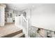 Carpeted staircase with white railings leading to the second floor, natural light and open space at 9120 Mastodon Ave, Las Vegas, NV 89149