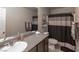 This bathroom features granite countertops and a shower with neutral curtain at 9160 Lynea Ct, Las Vegas, NV 89178