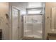 Modern bathroom featuring a tiled shower with a glass door and convenient grab bars at 9160 Lynea Ct, Las Vegas, NV 89178