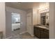 Bright bathroom with granite counters, tile flooring, and a glimpse into the connected bedroom at 9160 Lynea Ct, Las Vegas, NV 89178