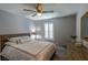 A cozy bedroom with white bedding, a wooden dresser, and shuttered window at 9160 Lynea Ct, Las Vegas, NV 89178