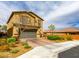 Stylish two-story home with a brick driveway, a two car garage, and manicured landscaping in a suburban neighborhood at 9160 Lynea Ct, Las Vegas, NV 89178