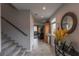 Bright hallway with staircase, neutral tones, stylish console table, and decor that leads to the living area at 9160 Lynea Ct, Las Vegas, NV 89178